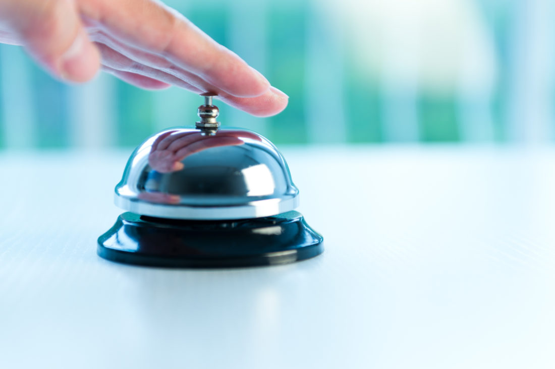 Hand ringing a bell for service