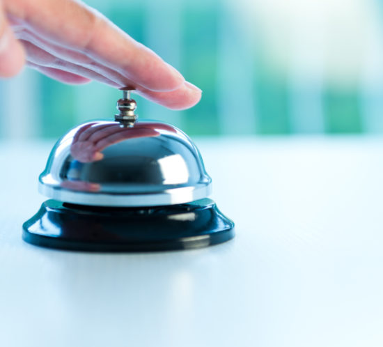 Hand ringing a bell for service